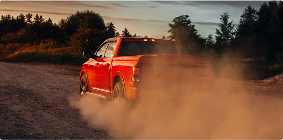 Red truck driving in dirt