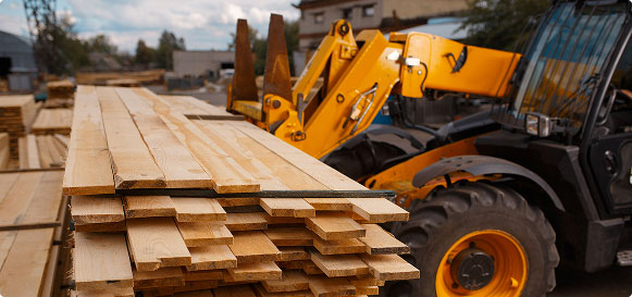 forklift moving pieces of wood