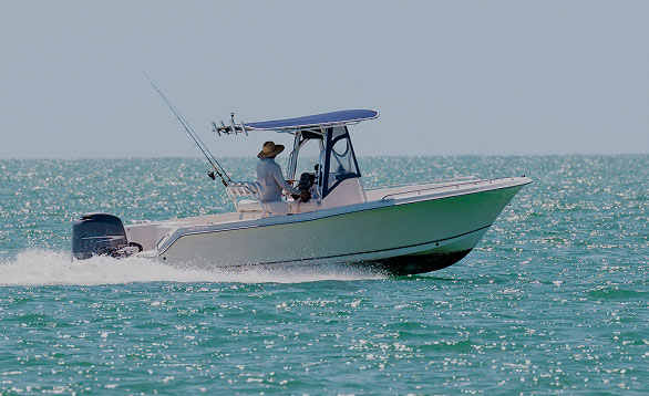 Person steering a fishing boat