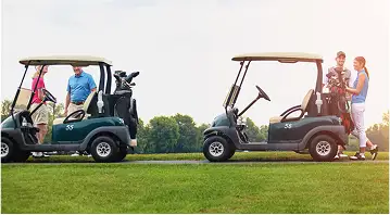 golfers hanging around two golf carts